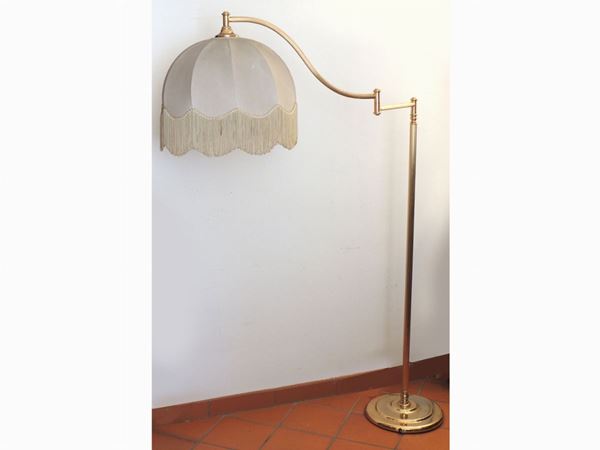A gilted metal floor reading lamp