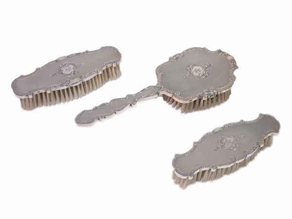 A silver and wood toilette set