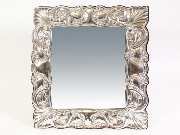 A silver toilet mirror