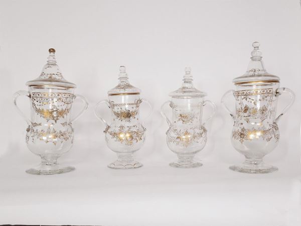Four glass pharmacy vases with lids
