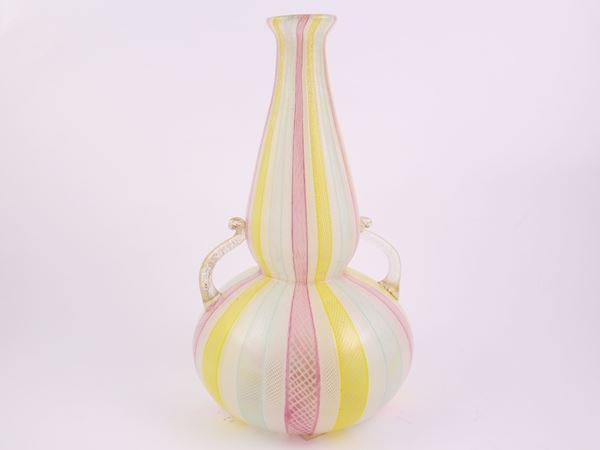 A blown reticello and zanfirico glass vase with applied handles