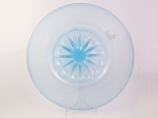 A large blown light blue glass plate