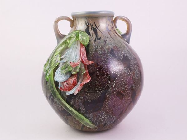 A glass blown vase with big flowers applied