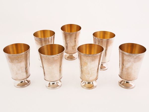 A set of seven silver glasses