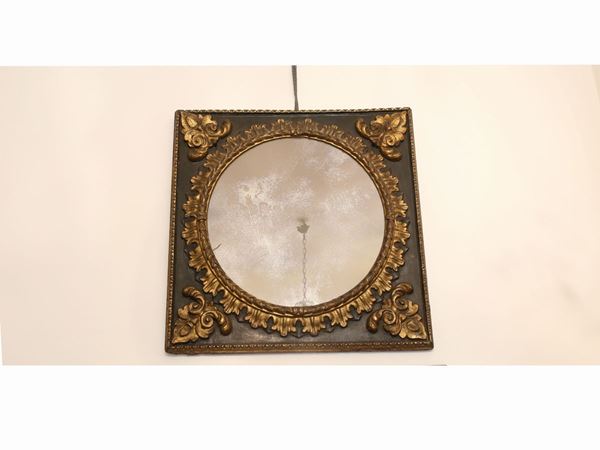 An ebonized wood and papier-mache frame highligthed in gold