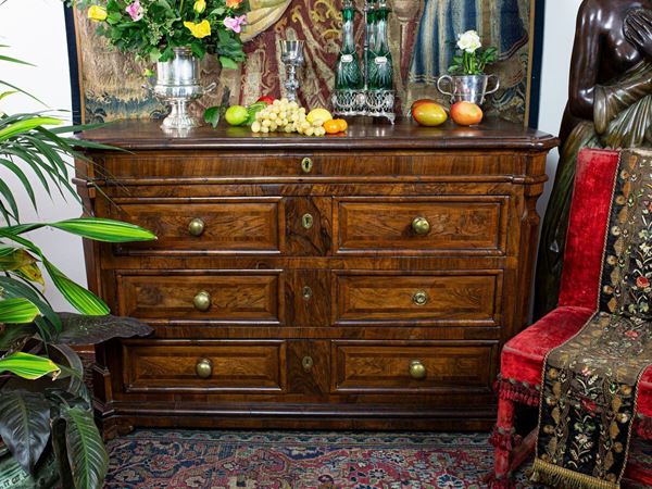 A walnut veneered chest of drawers