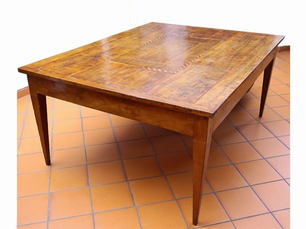 A large veneered cherry wood dining table