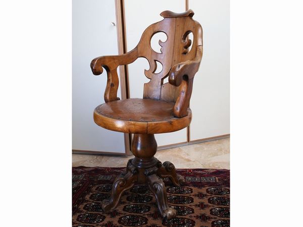 A pair of cherrywood revolving armchairs