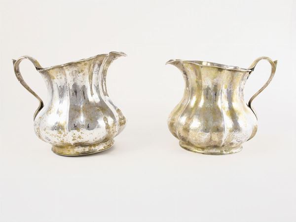 A pair of silver pitchers