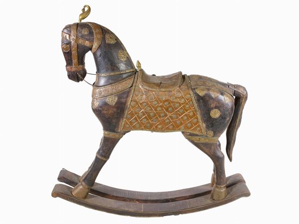 A wooden and tole rocking horse