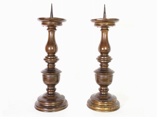 A pair of patinated bronze candelabra
