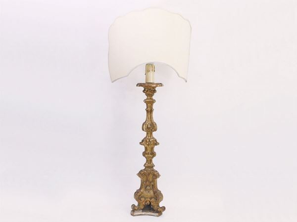 A gilded and curved wood candelabra