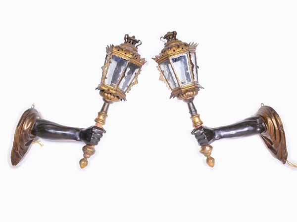 A pair of laquered and gilted wooden arms lamp holders