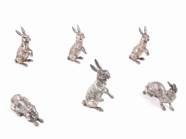 A set of five sterling silver salt shakers in the shape of hares