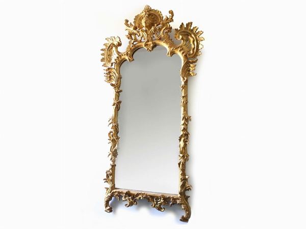 A giltwood and curved mirror