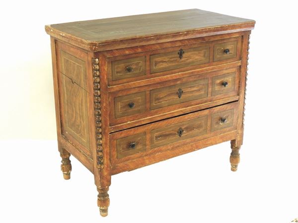 A small lacquered chest of drawers
