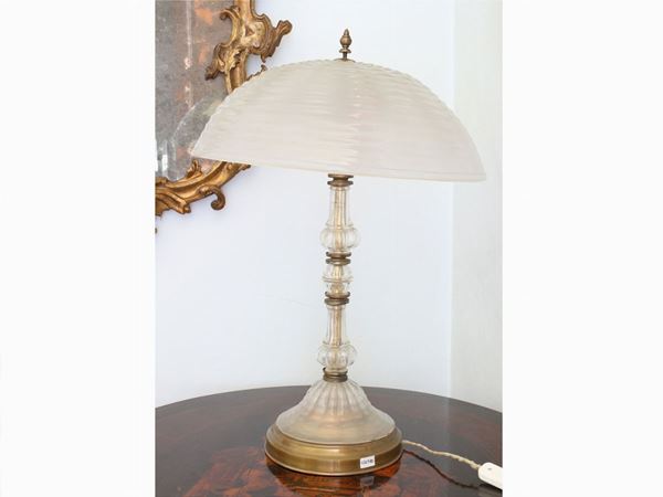 A glass and brass table lamp