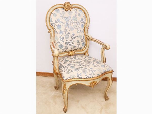 A giltwood, curved and lacquerd armchair