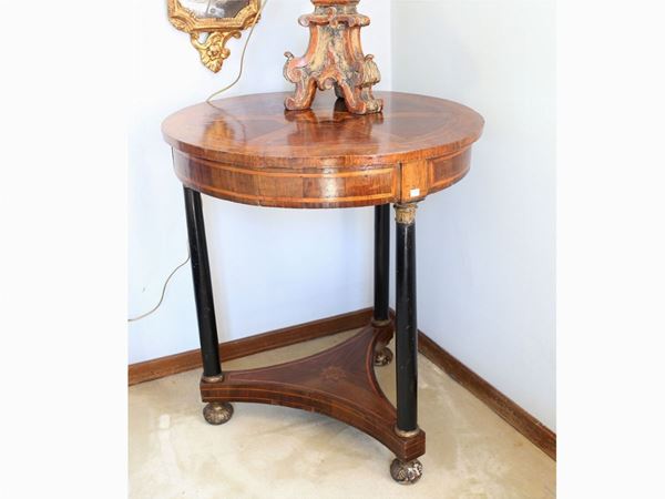A walnut veneered round table