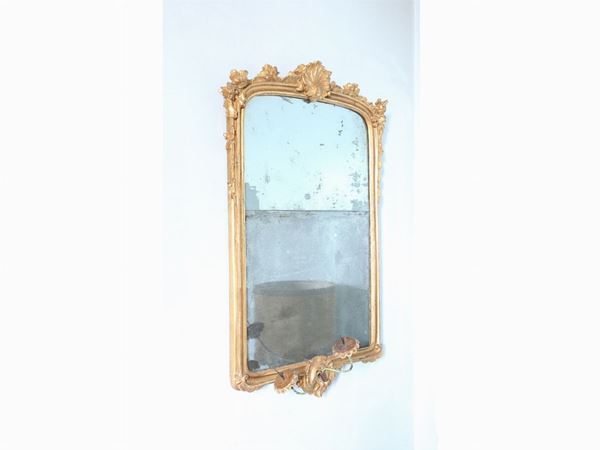 A gilted and curved wooden mirror
