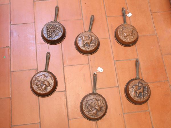 A set of six small copper pans