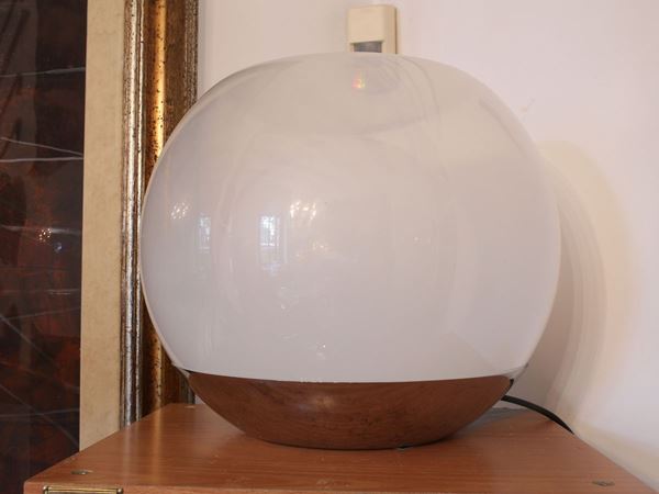 A blown glass and metal table lamp