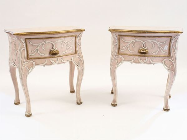 A pair of laquered bedside tables