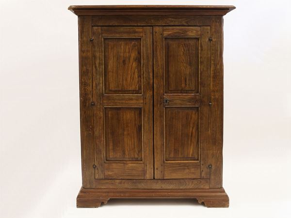 A chestnut wood small wardrobe