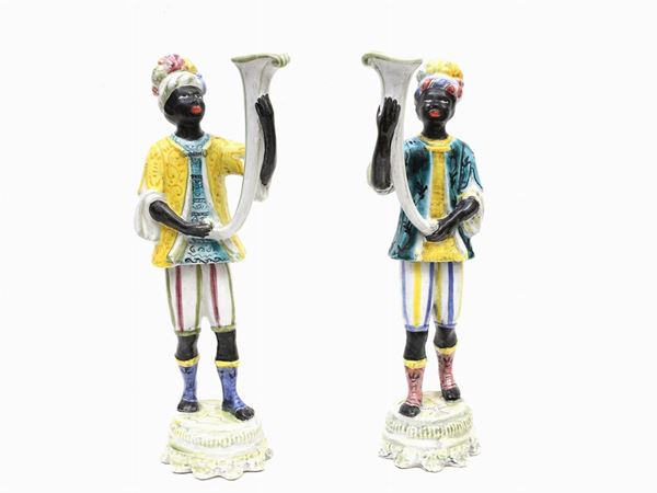 A pair of glazed and painted terracotta Mori