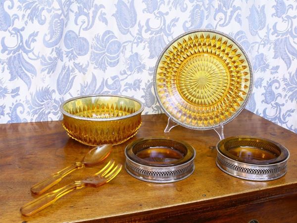 A silver and yellow glass table set