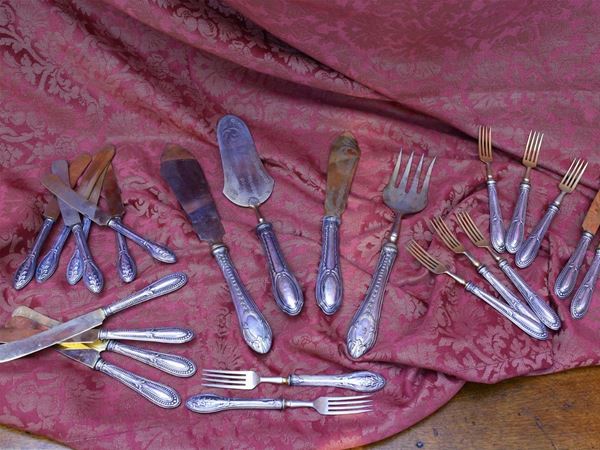Two silver and gilted metal dessert cutlery sets