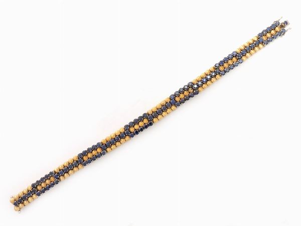 White and yellow gold bracelet with sapphires
