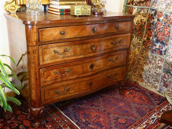 A walnut veneered chest of drawers