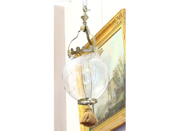 A blown glass and gilted metal lamp