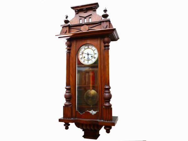 A walnut wall clock with a barometer