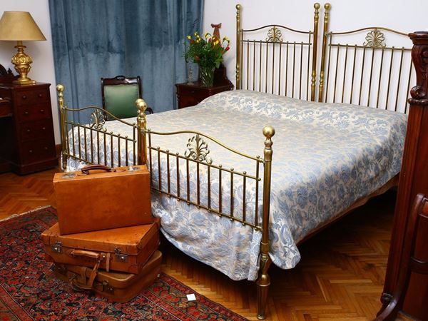 A pair of single brass beds