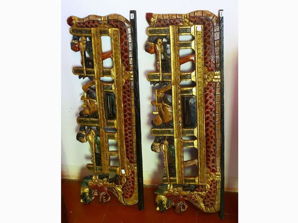 A pair of giltwood and lacquered oriental friezes