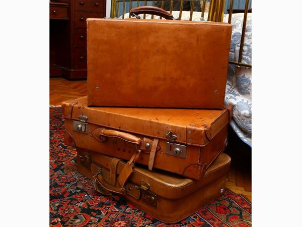 Three vintage leather suitcases