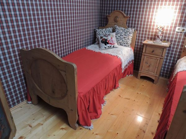 A child's Tyrolean softwood bed and fabrics