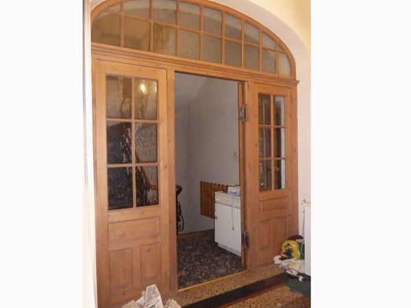 A large arched shape wooden and glass atrium door