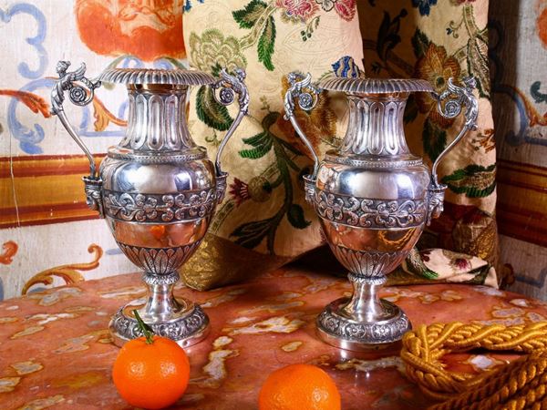 A pair of silver vases