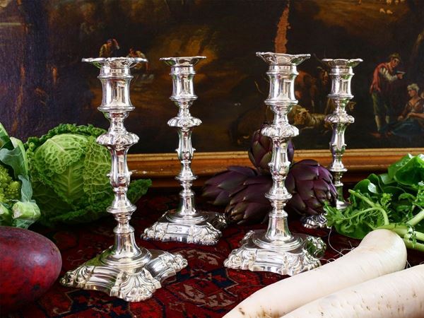 A set of four silver plated candlesticks