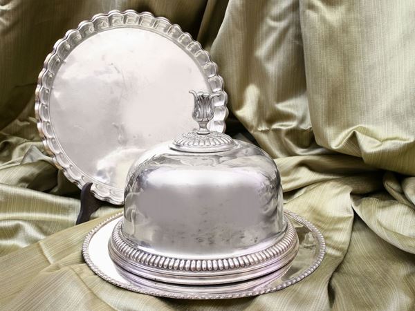 A silver plated copper tray with a cloche