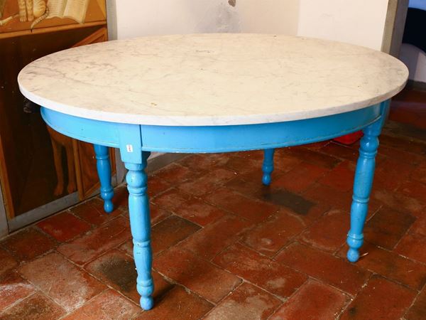 An oval table with circular white marble top