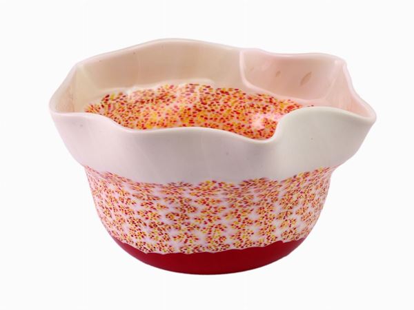 A cup with white and red murrine glass