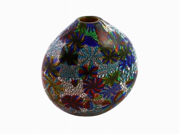 A glass vase with a decor of polychrome stars murrines and silver leaf