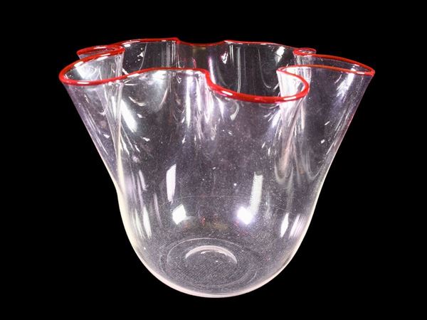A trasparent handkerchief vase with red rim applied