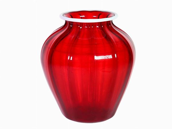 A ruby red glass vase with lattimo rim
