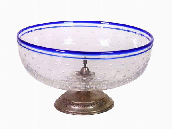 A glass bowl with blue rim and silver base