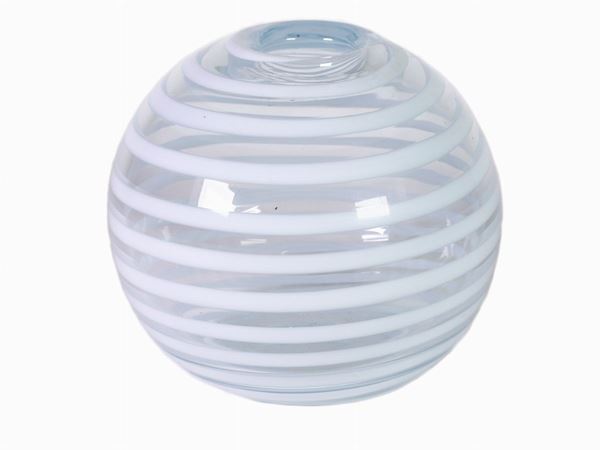 A trasparent spherical glass vase with lattimo spiral stripes